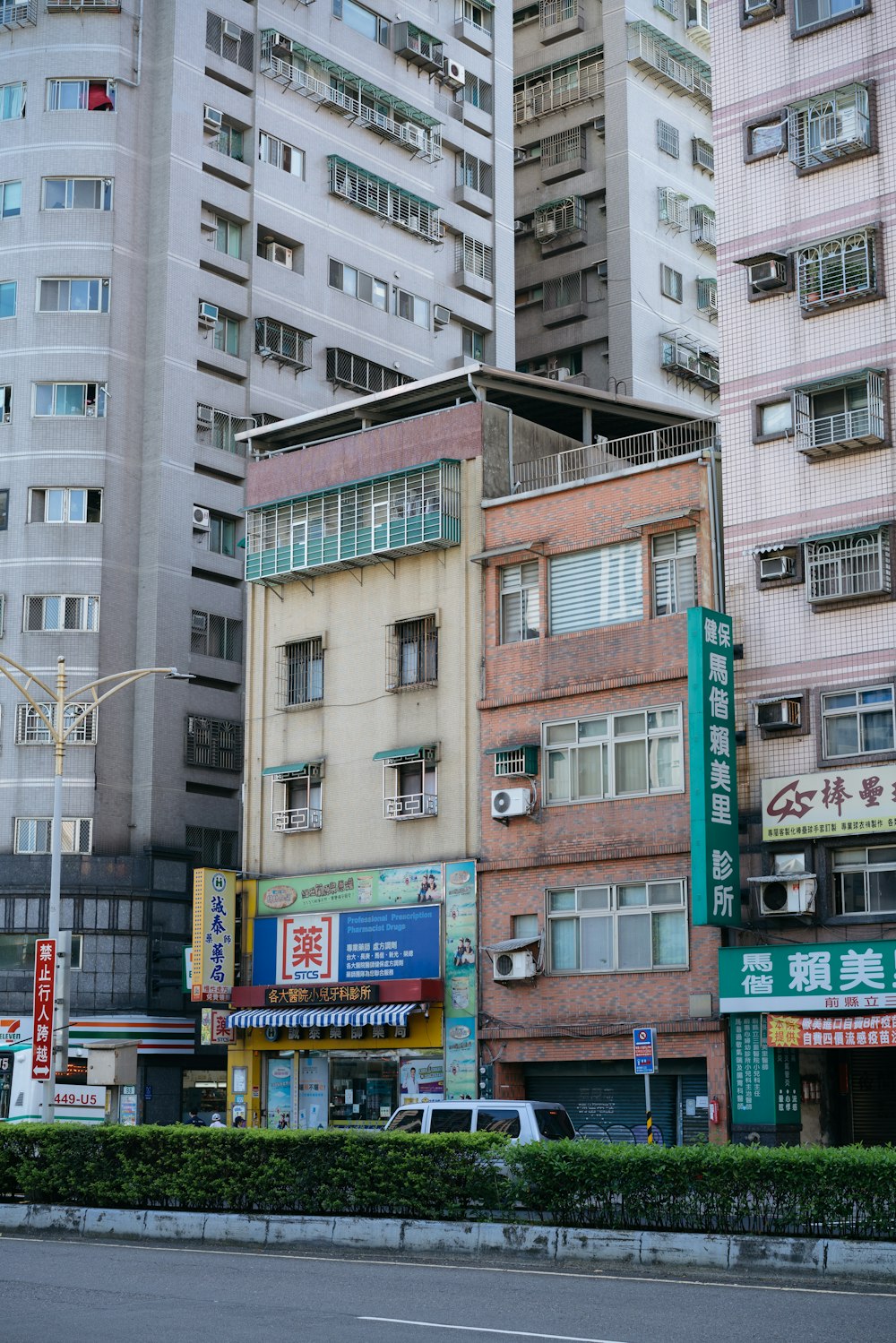 a city street with tall buildings in the background