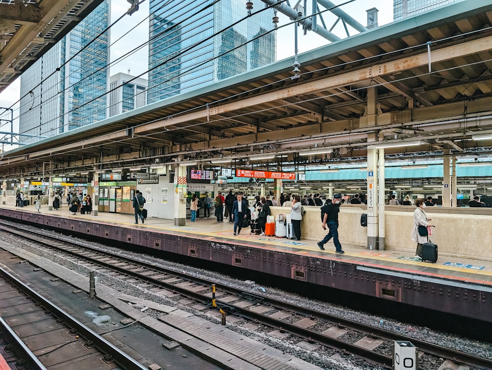 a group of people standing on a train platform