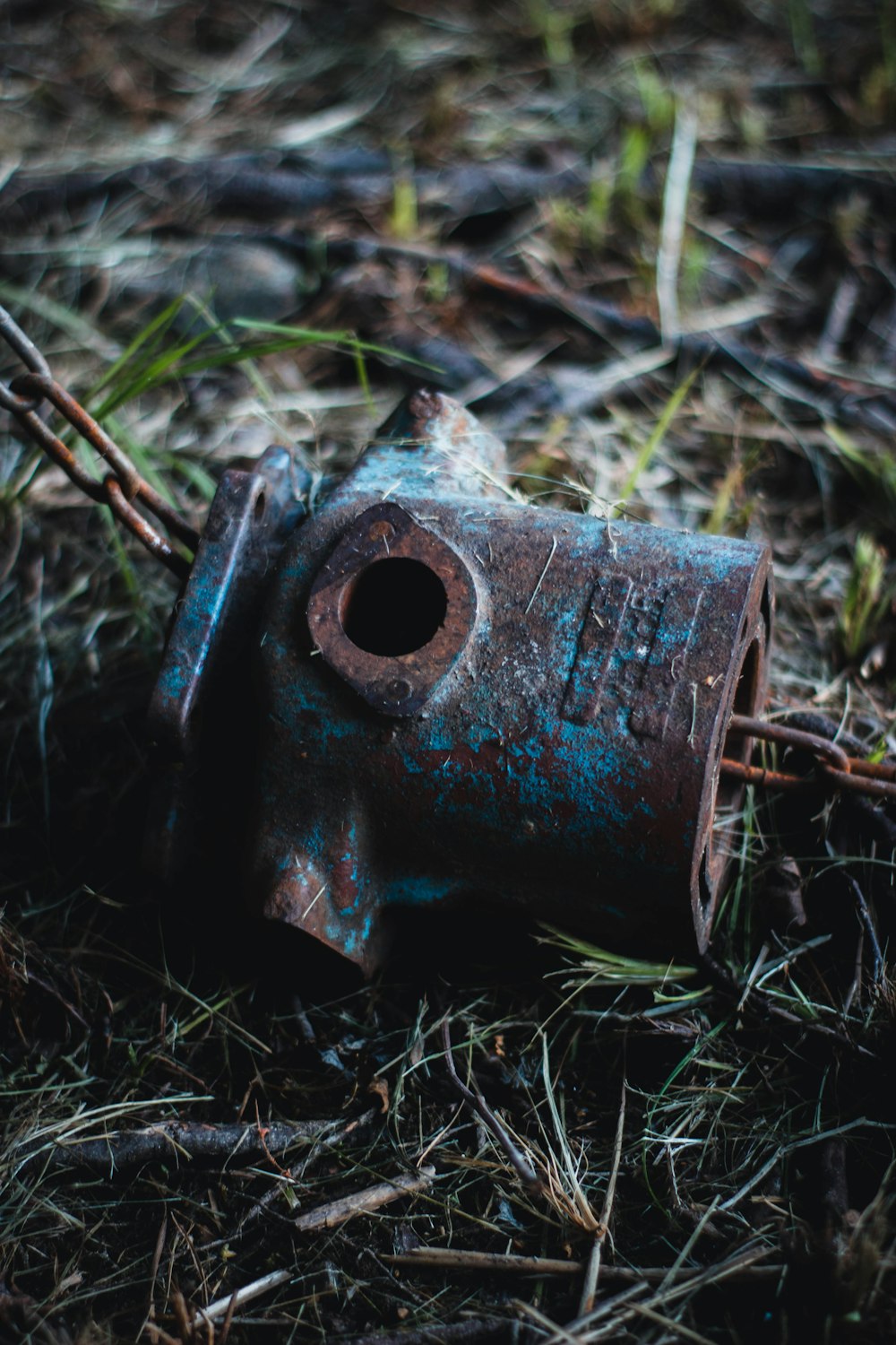 a rusted metal object laying on the ground