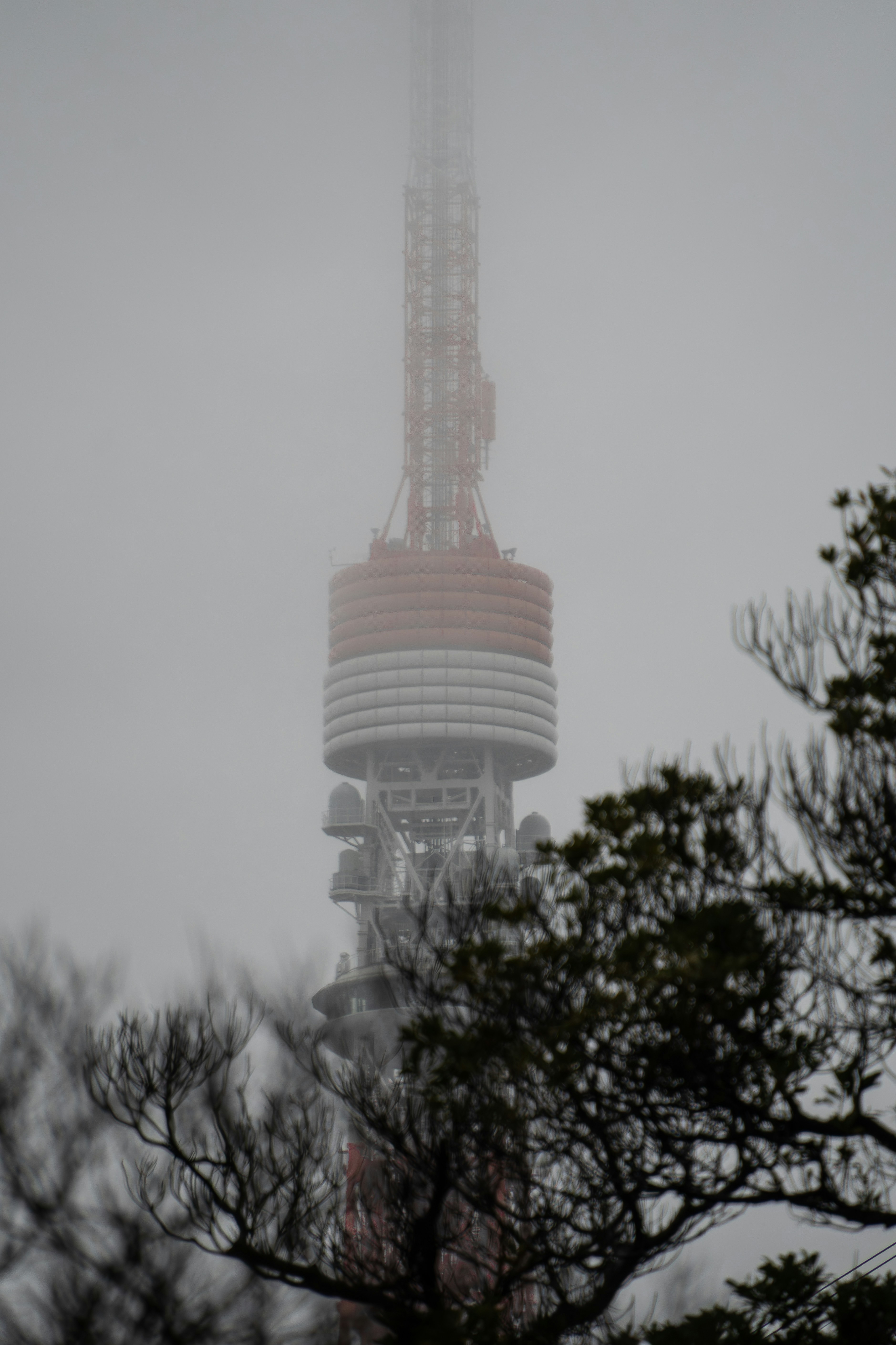 A very tall tower with a very tall clock on it's side