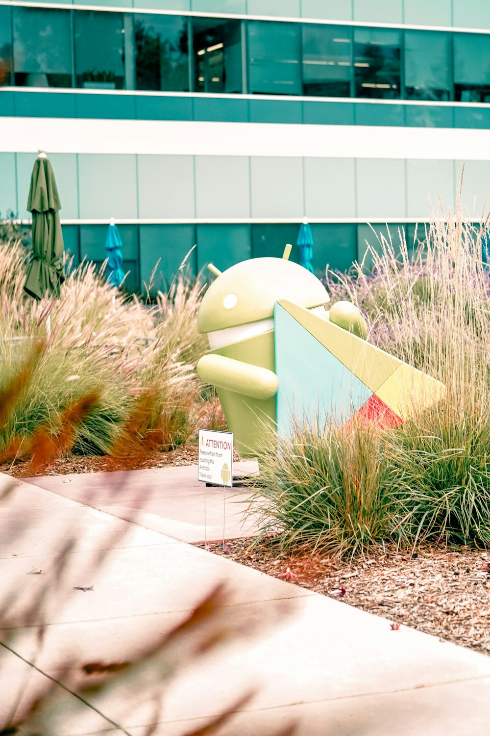 a sculpture of a frog in the middle of a garden