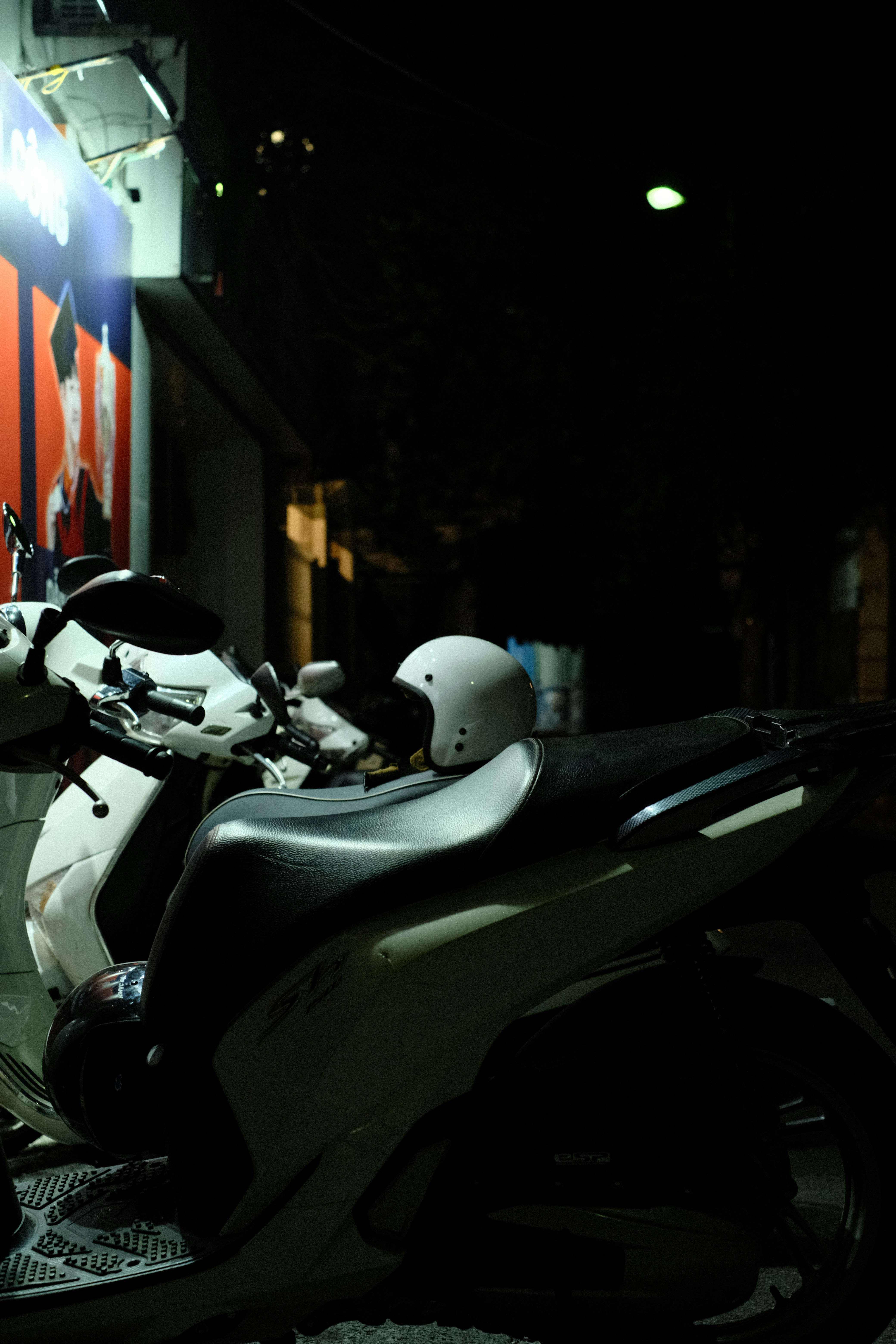 a motorcycle parked in front of a building at night