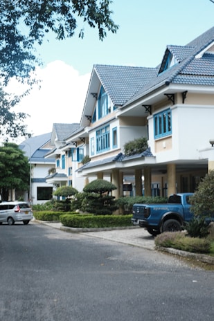 a blue truck is parked in front of a row of houses