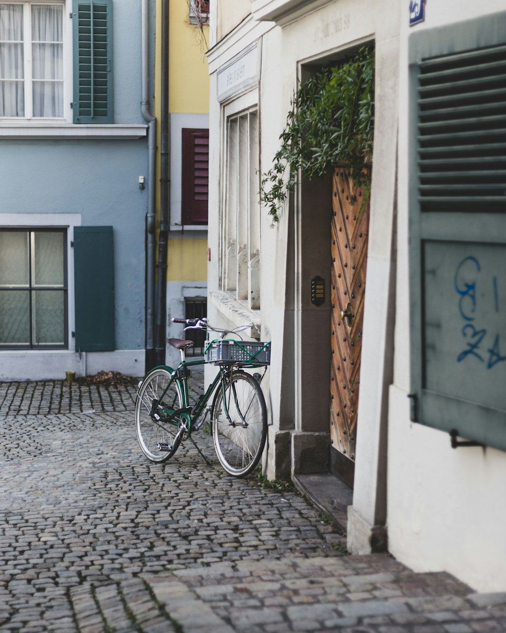 a bicycle is parked on a cobblestone street