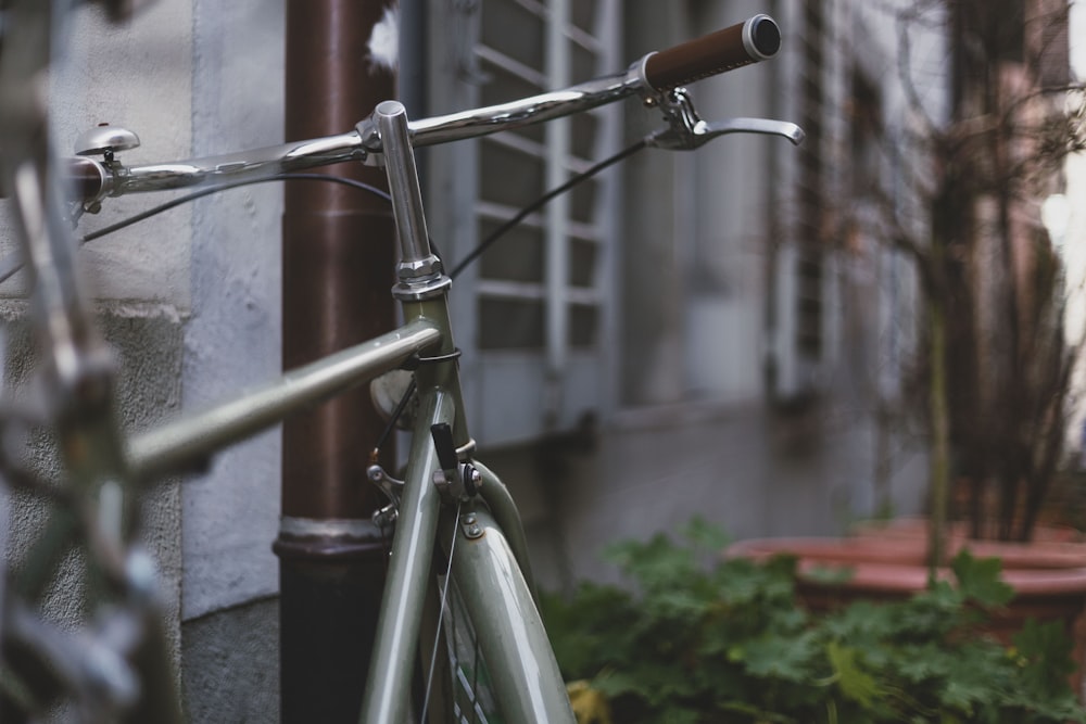 a close up of a bike parked next to a building