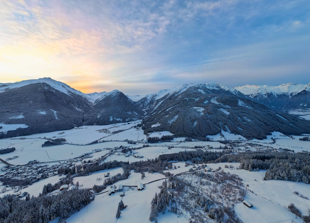 an aerial view of a snowy mountain range