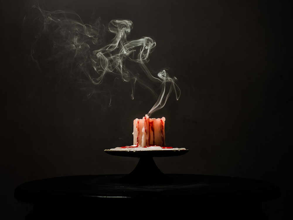 a cake with smoke coming out of it on a plate