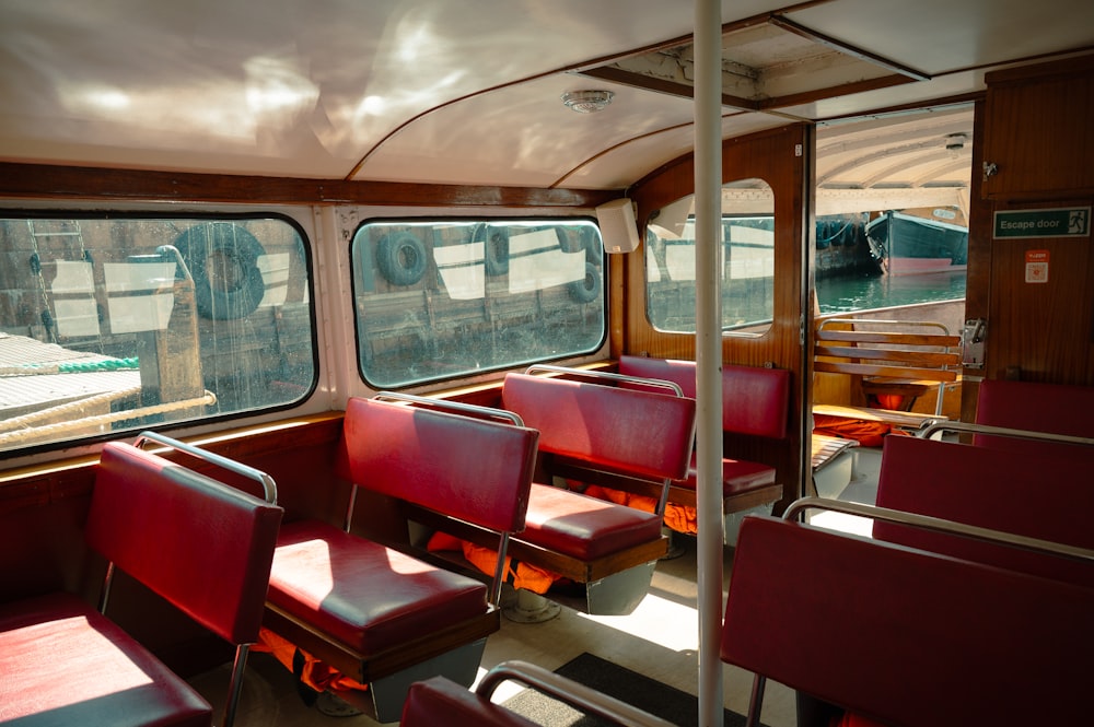 the inside of a train car with red seats
