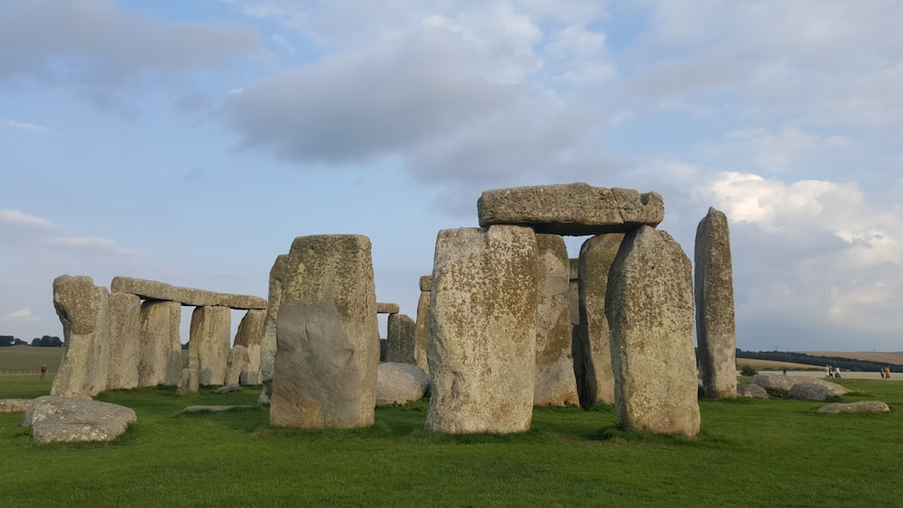 a group of stonehenges in a grassy field