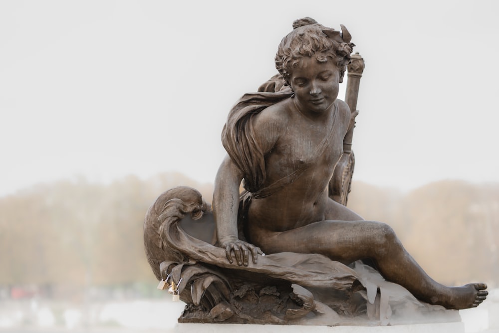 a statue of a woman sitting on top of a table