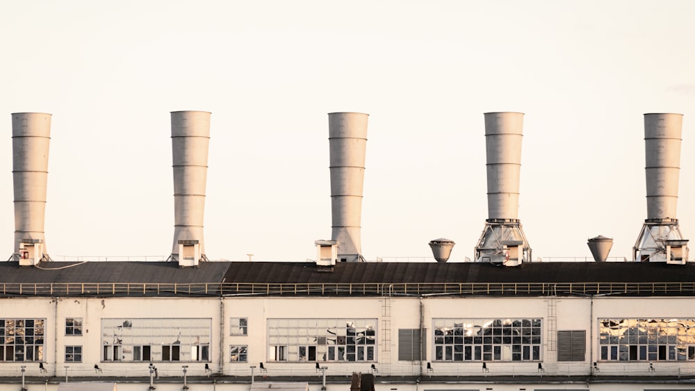 a row of smoke stacks in front of a building