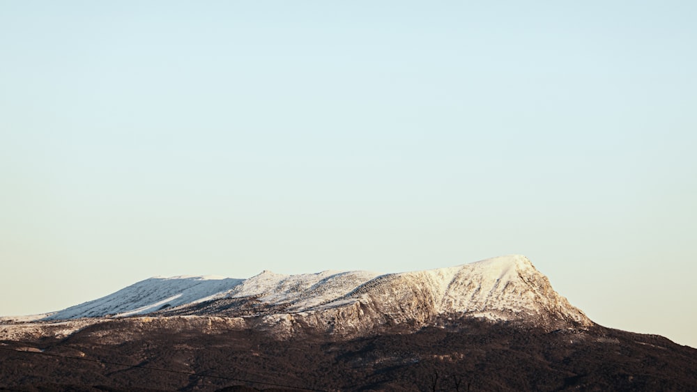 a snow covered mountain with a sky background