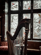 a harp sitting in front of a stained glass window