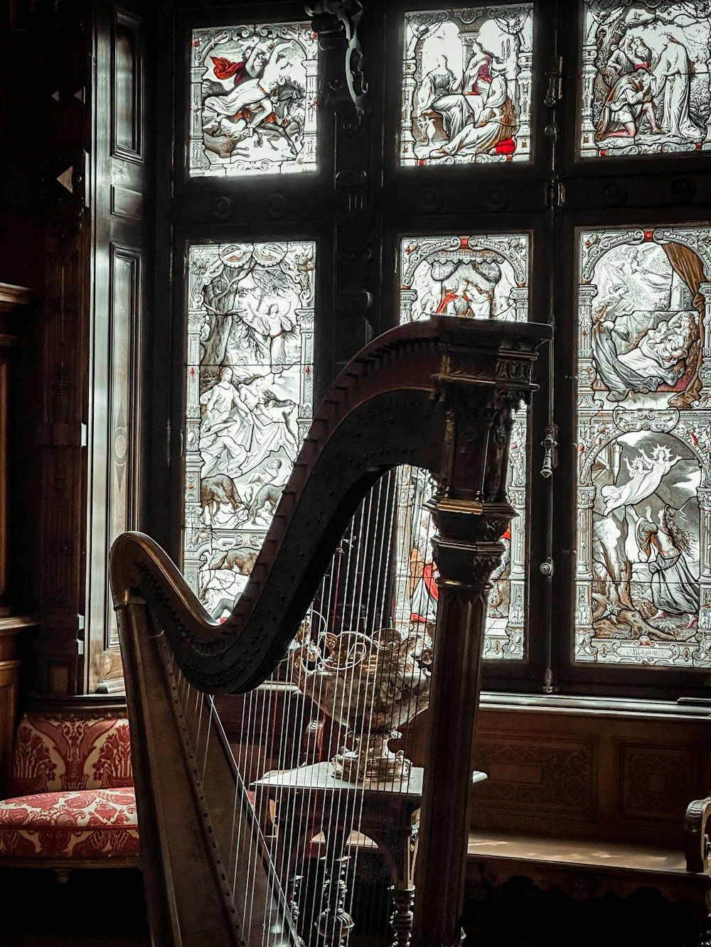 a harp sitting in front of a stained glass window