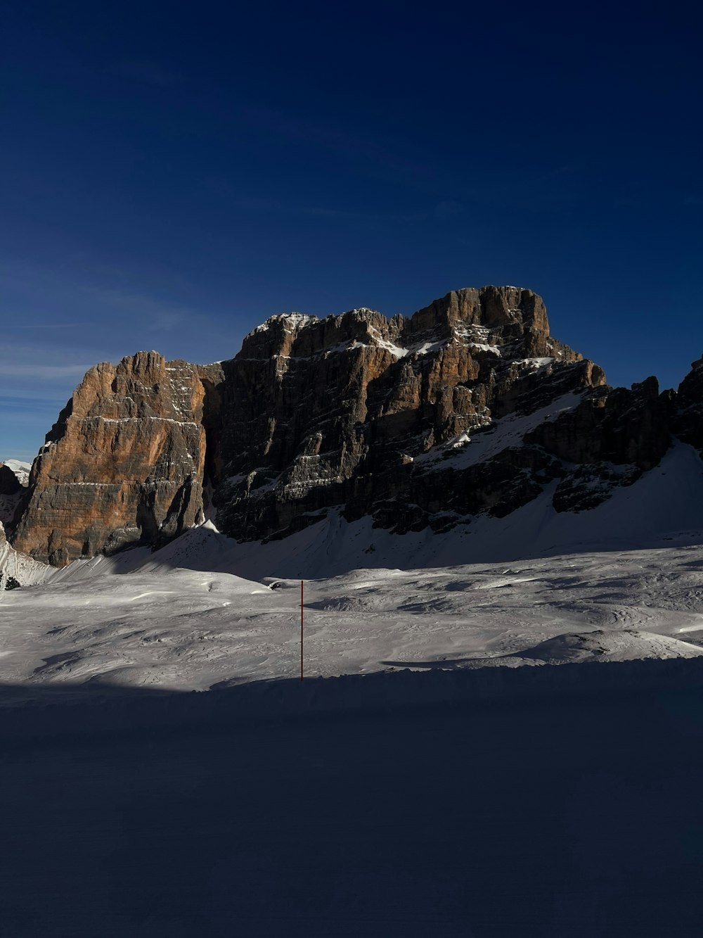 a person on skis in the snow with mountains in the background