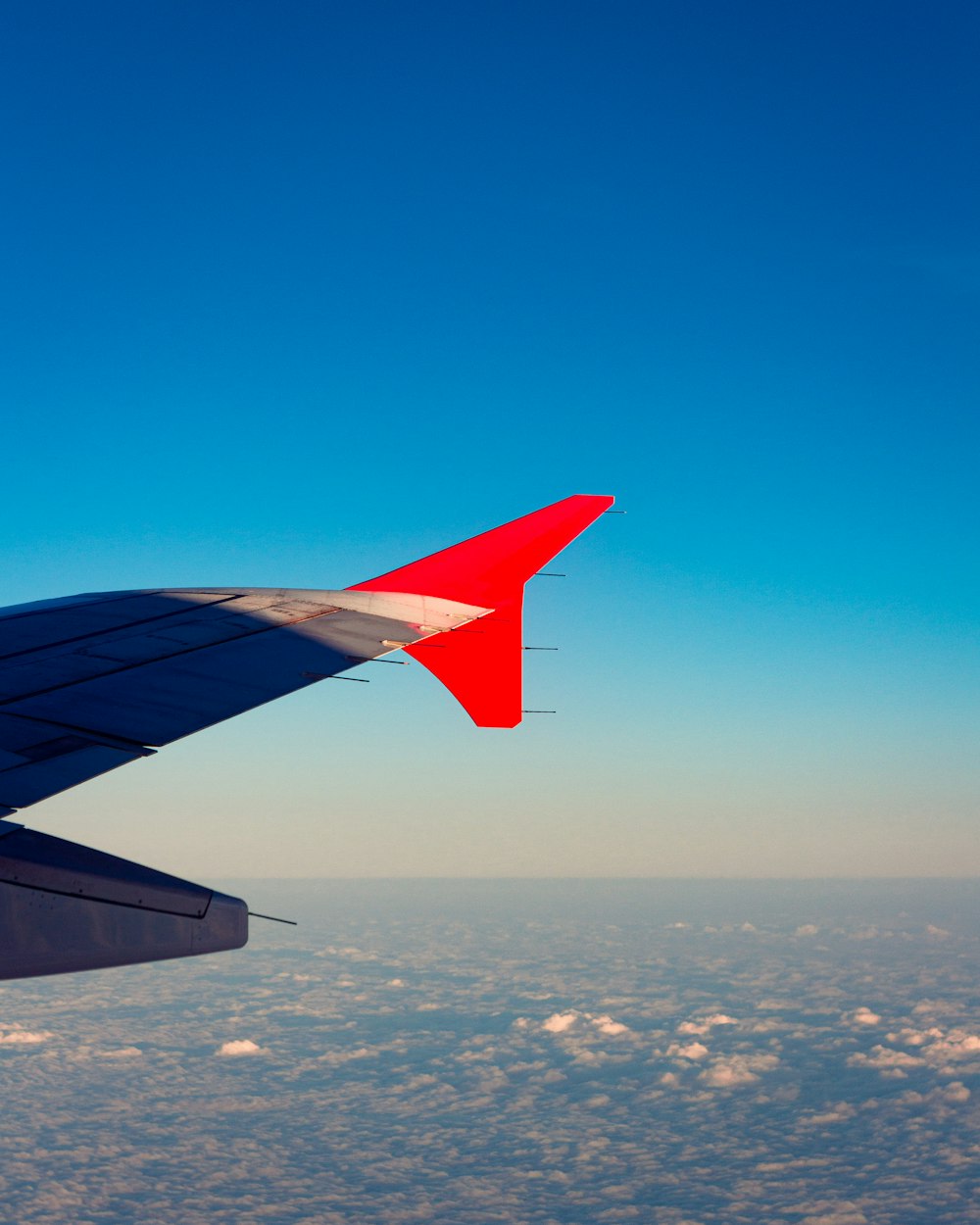 a view of the wing of an airplane in the sky