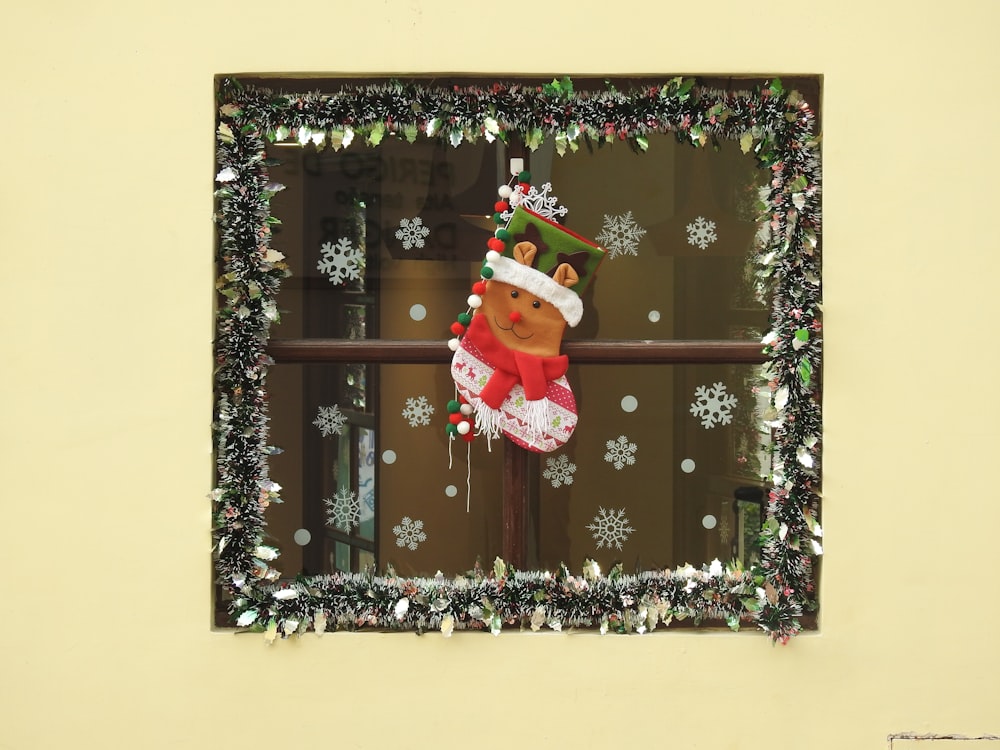 a window with a christmas decoration on it