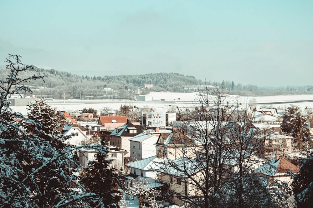 a view of a snowy town from a hill