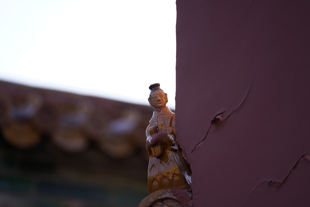 a small figurine on the side of a building