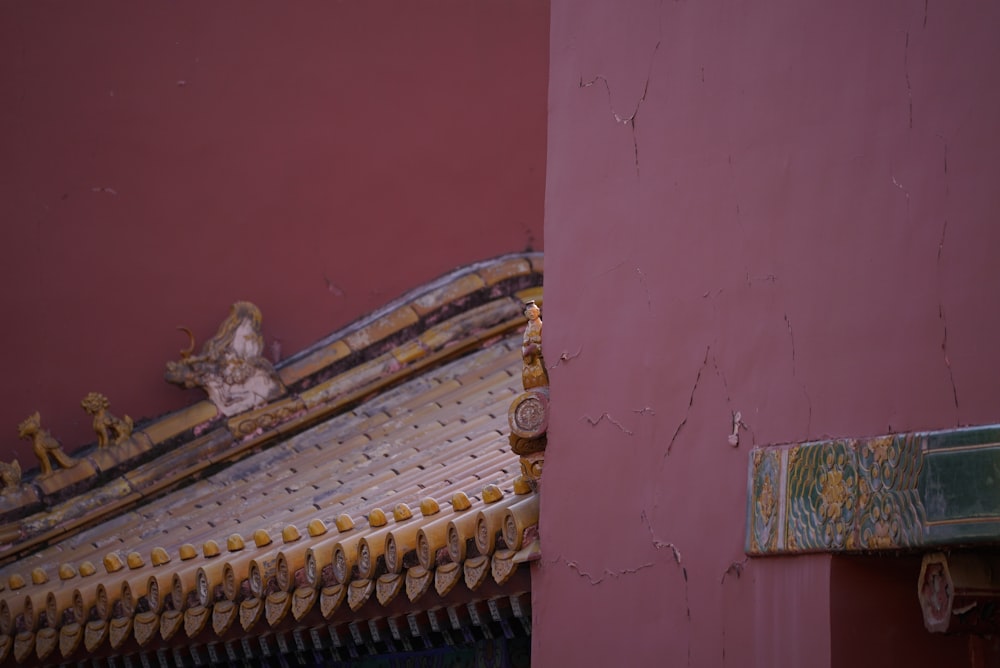 a close up of a bed with a wall in the background