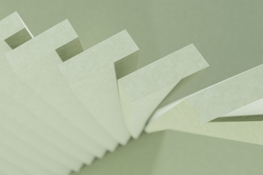 a stack of white papers sitting on top of a table