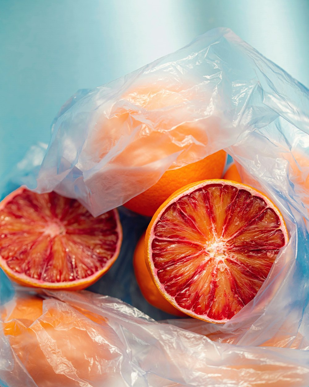 a grapefruit cut in half in a plastic bag
