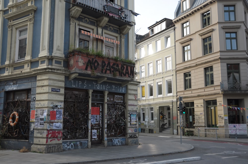 a street corner with a building with graffiti on it