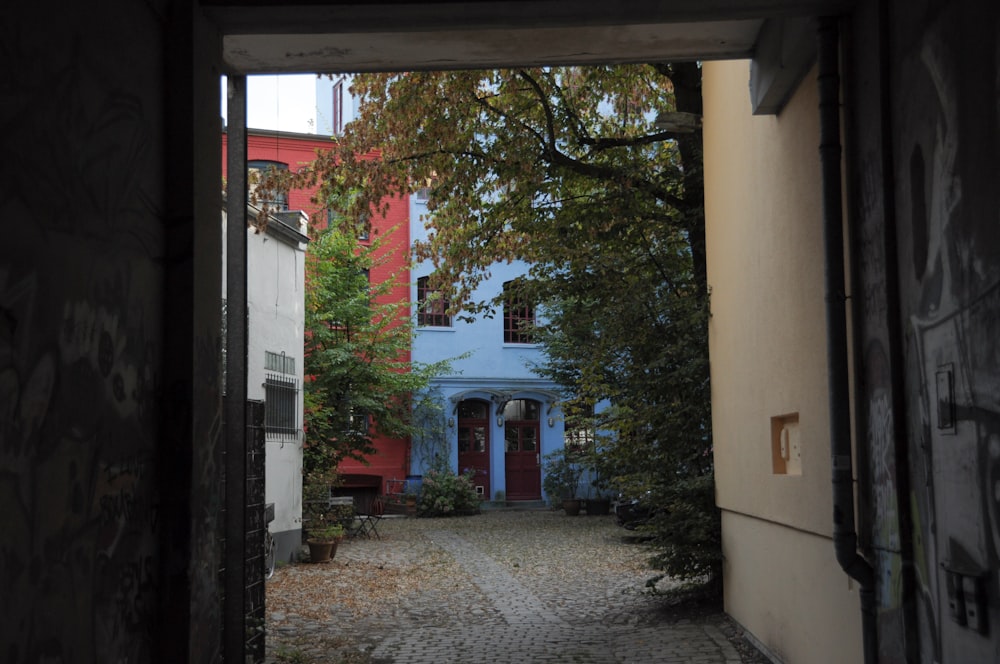 an open door leading to a building with graffiti on it