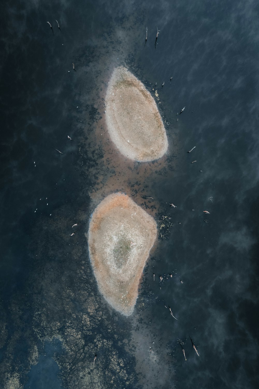 an aerial view of two small islands in the ocean