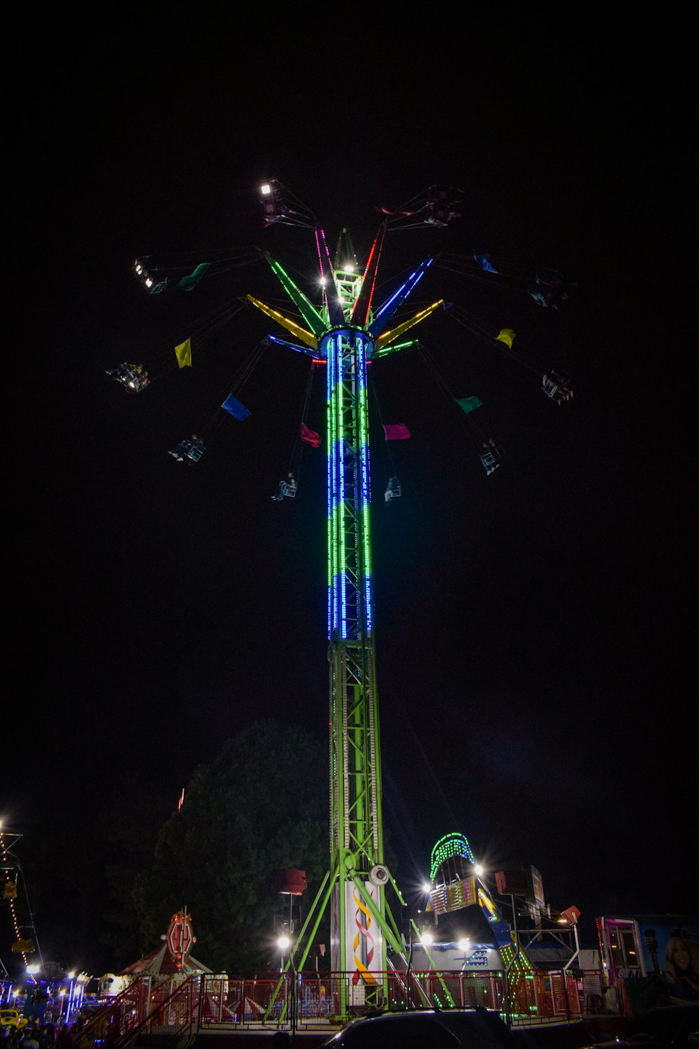 a ferris wheel lit up at night at a carnival