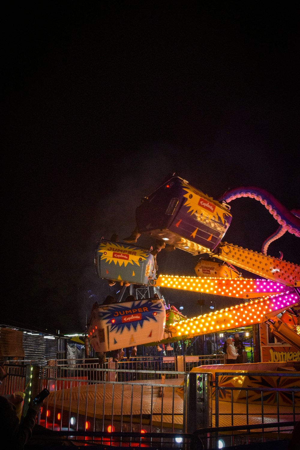 a carnival ride at night with people on it