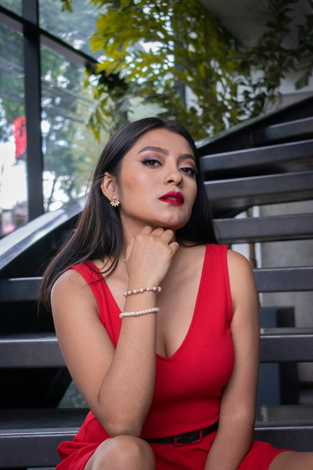 a woman in a red dress sitting on a bench