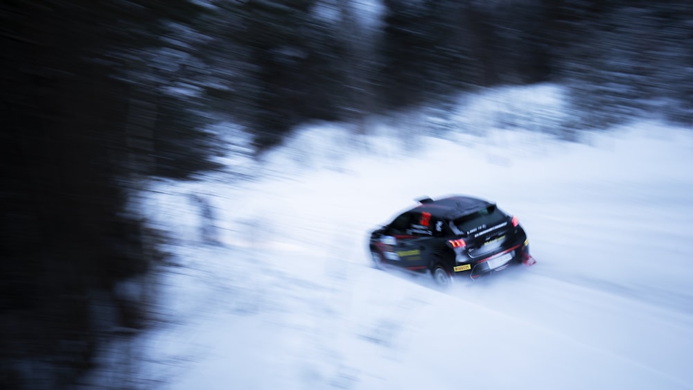 a car driving down a snow covered road