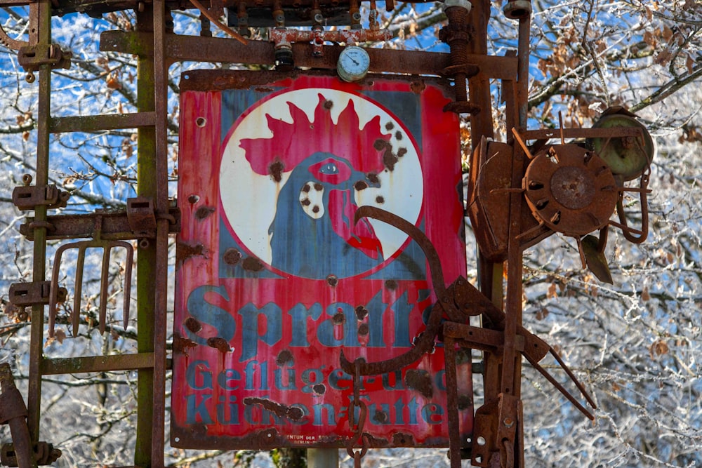 a rusted metal sign with a rooster on it
