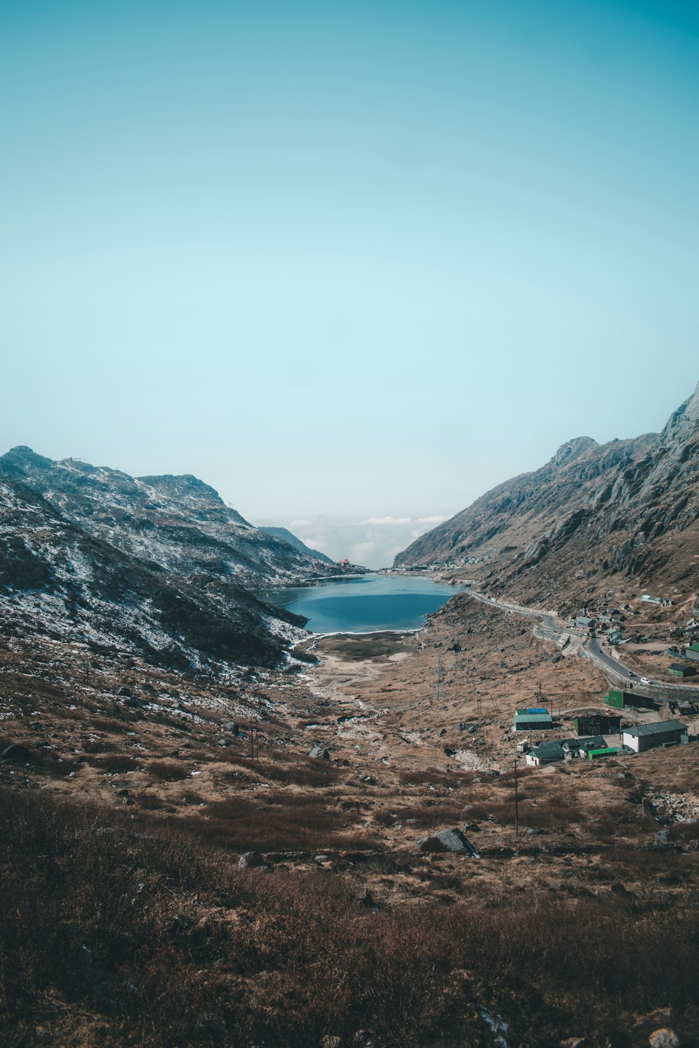 a scenic view of a lake surrounded by mountains