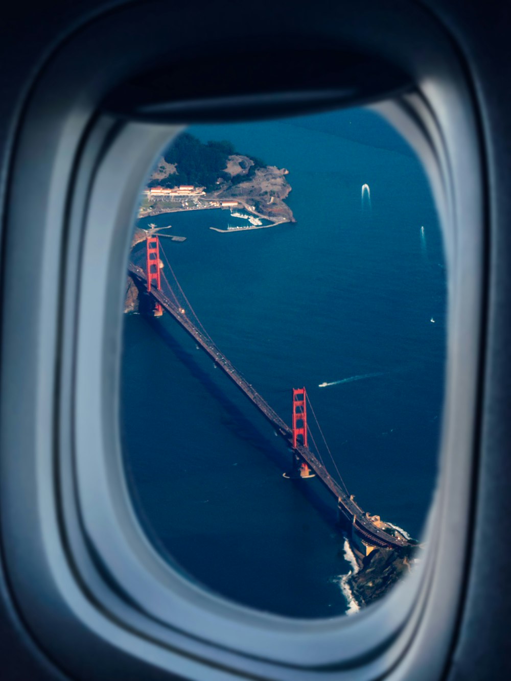 a view of the golden gate bridge from an airplane window