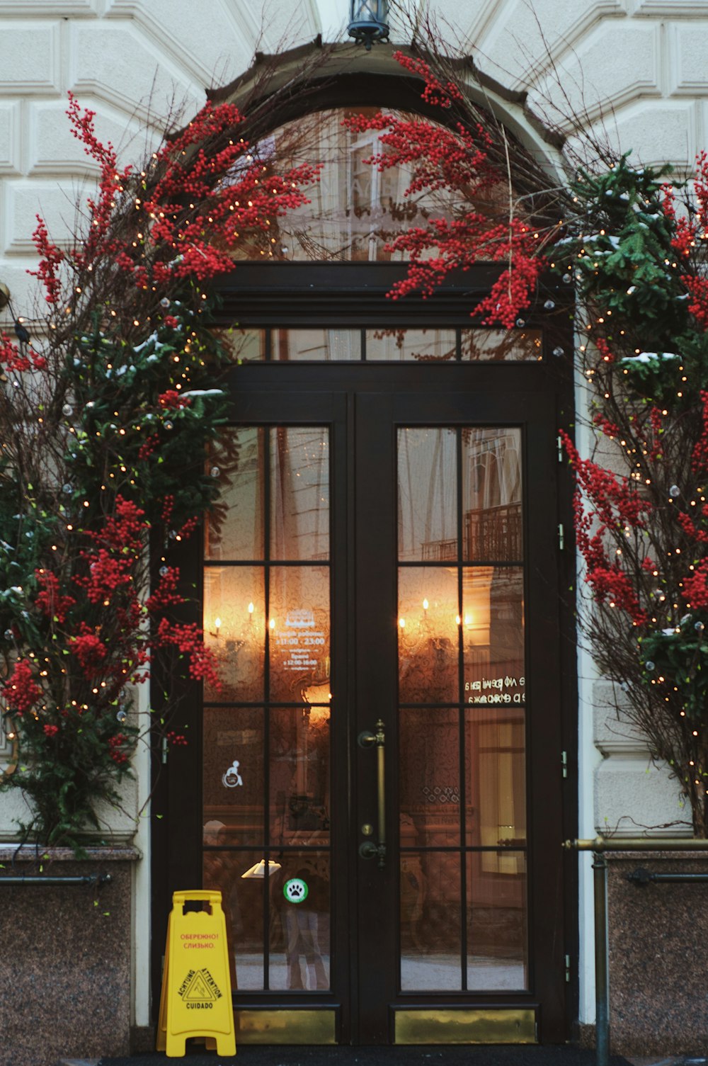 a large black door with red flowers on it