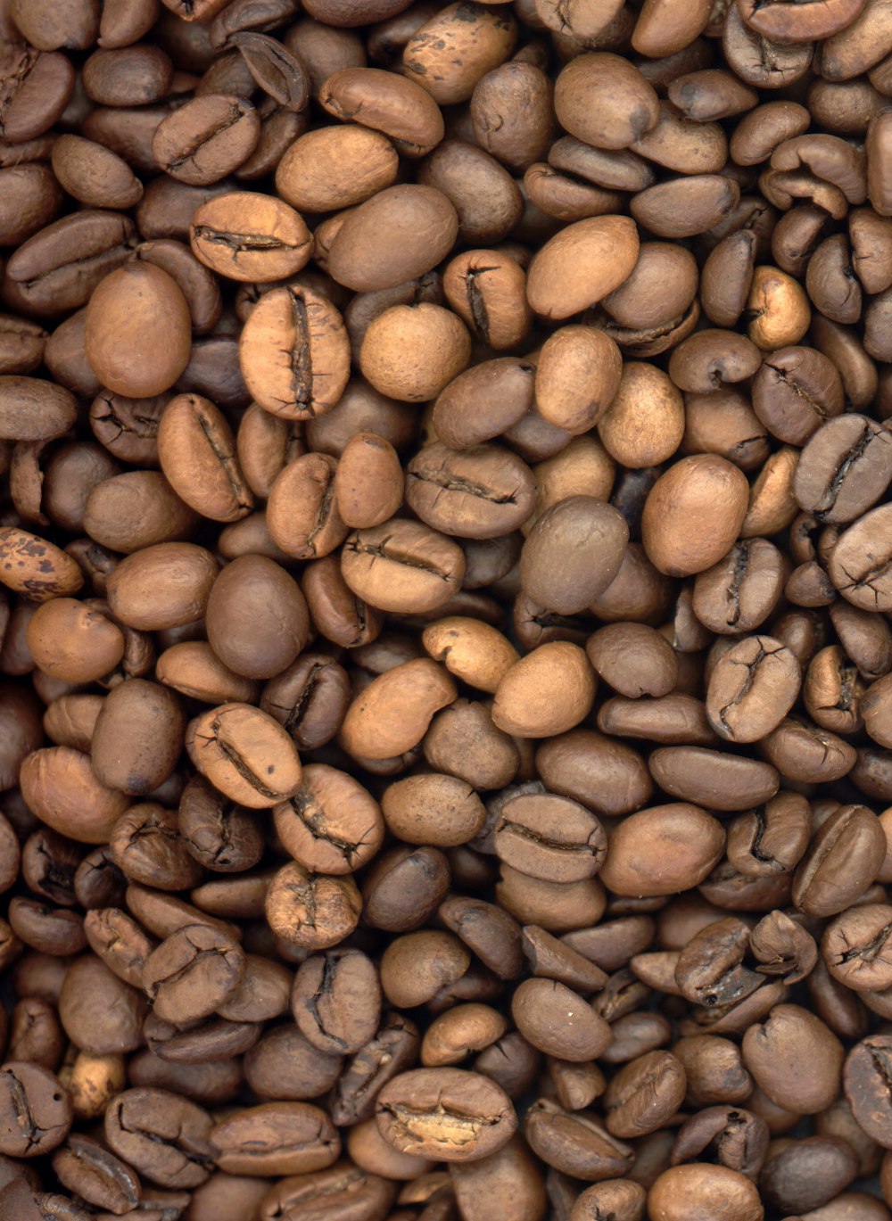 a pile of coffee beans sitting on top of each other