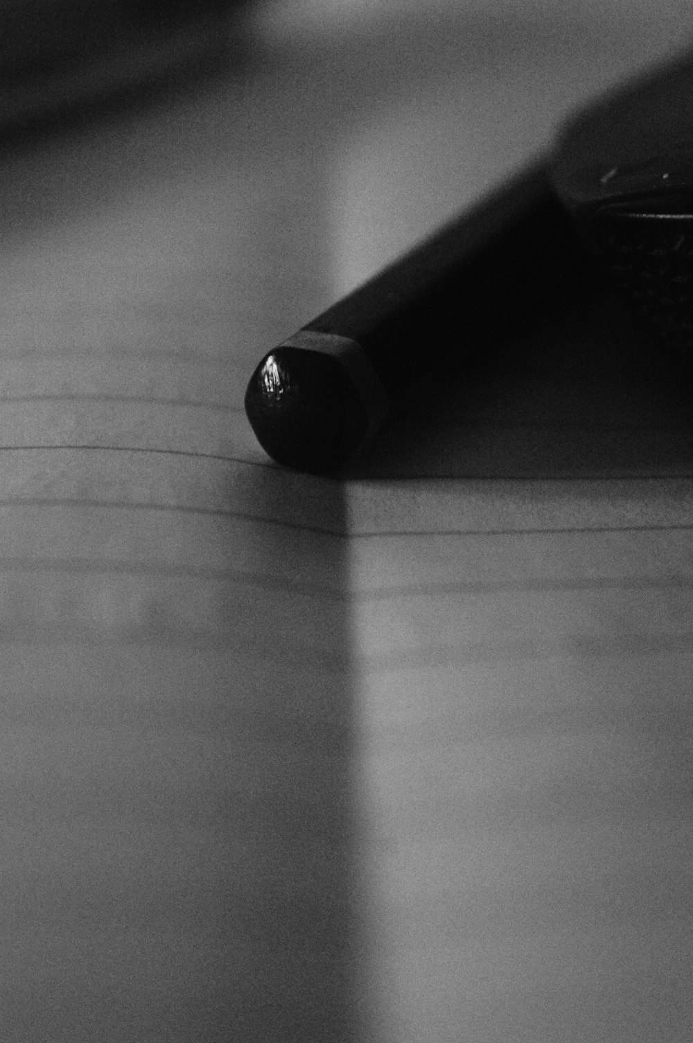 a black pen sitting on top of a wooden table