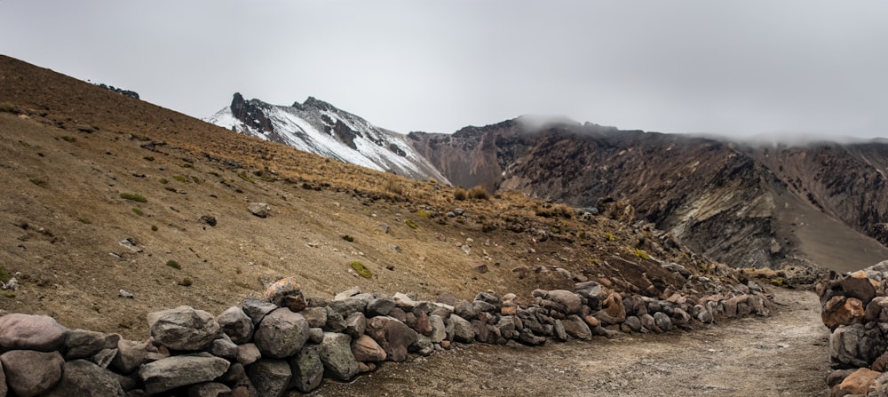 a stone wall on the side of a mountain