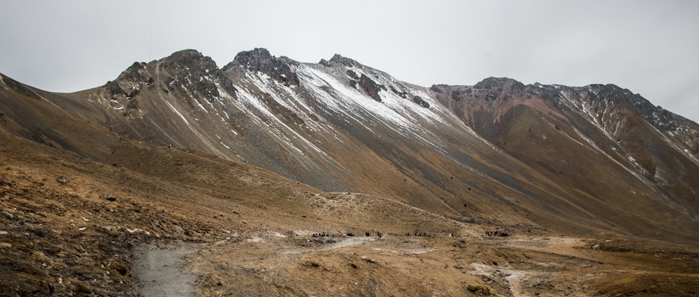 a mountain with a stream running through it