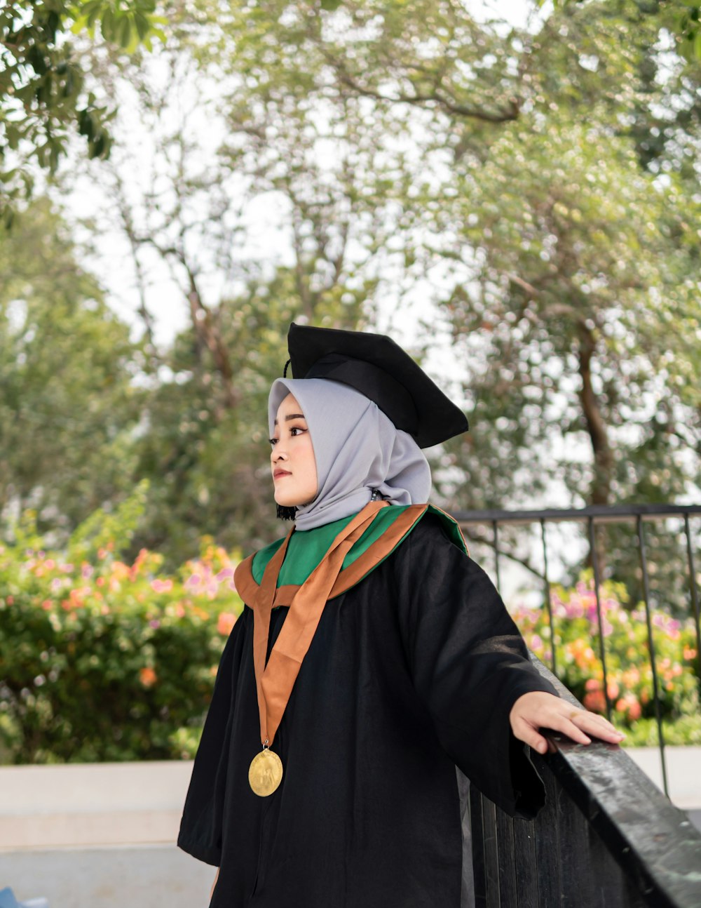 a woman in a graduation gown and a medal