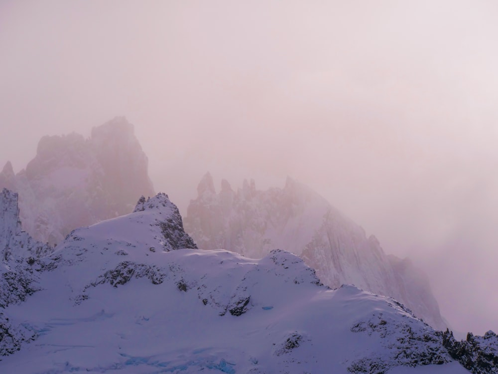 a mountain covered in snow with a sky background