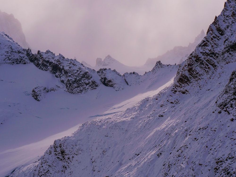 a mountain covered in snow with a sky background