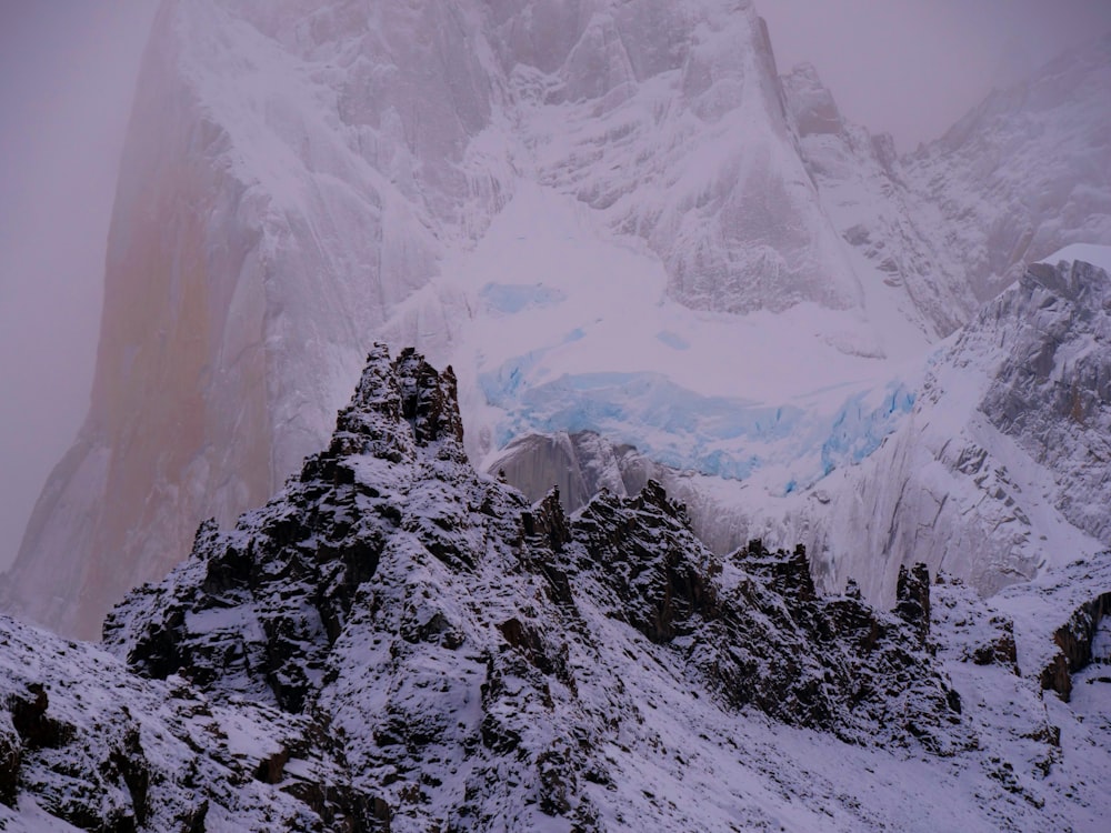 a mountain covered in snow with a very tall peak