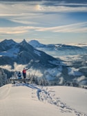 a person standing on top of a snow covered mountain