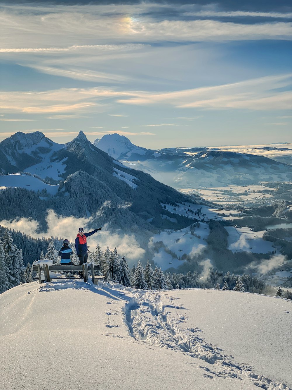 a person standing on top of a snow covered mountain