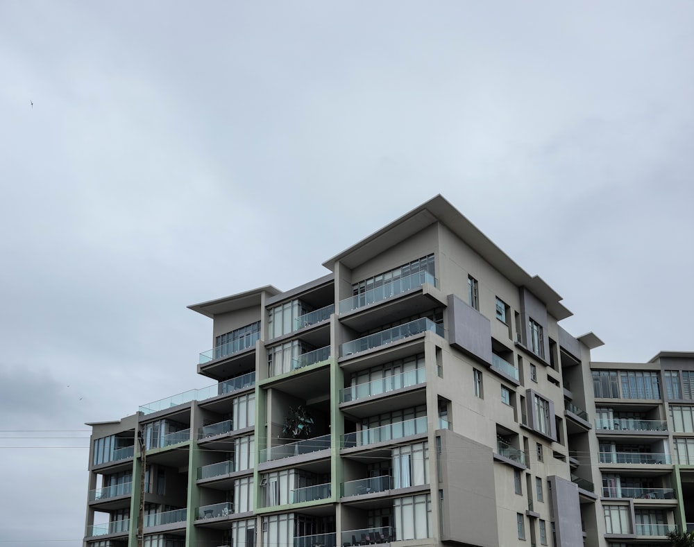 an apartment building with balconies and balconies on the second floor