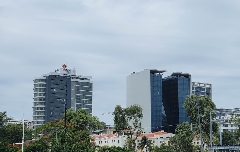 a couple of tall buildings sitting next to each other