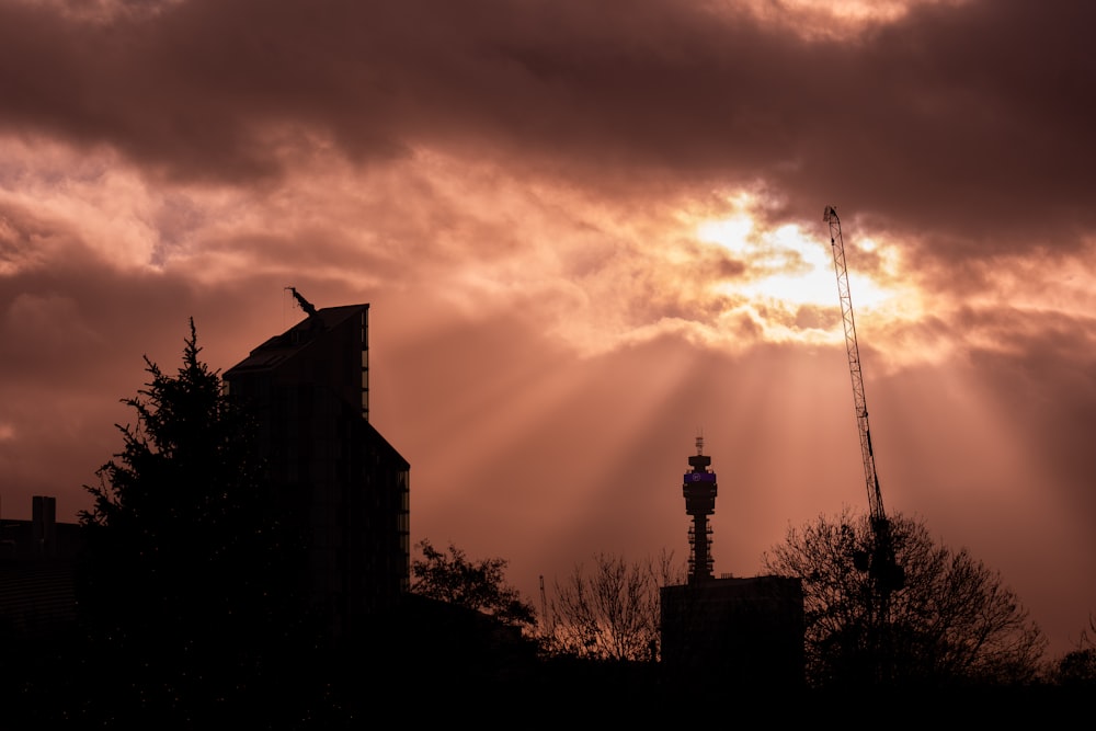 the sun is shining through the clouds over a building